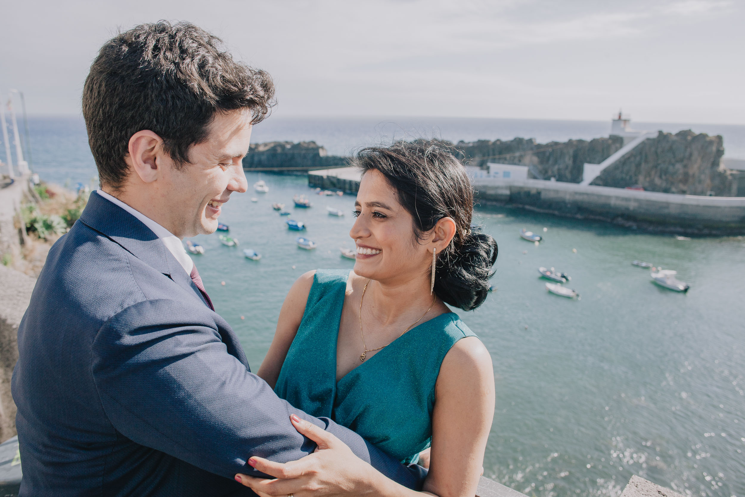 Couple laughing above the fishing boats at Câmara de Lobos, Madeira
